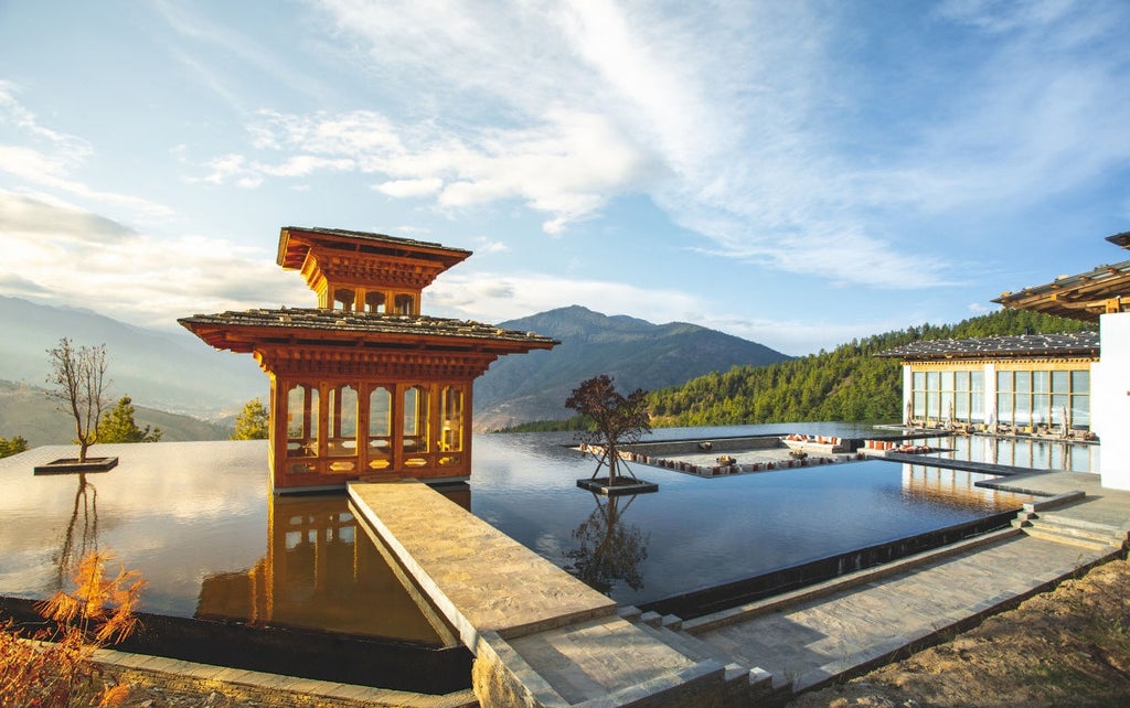 Luxurious mountain lodge with traditional Bhutanese architecture, stone walls and wooden beams, overlooking misty Thimphu valley at sunset