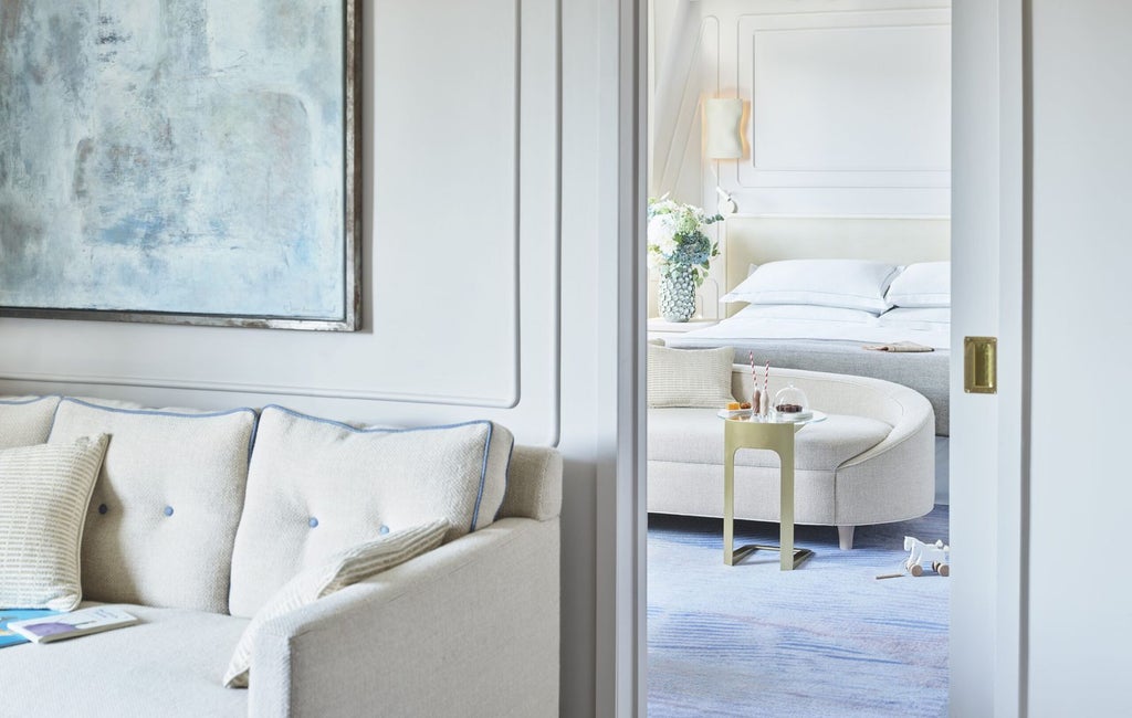 Luxurious deluxe hotel room at One Aldwych with elegant contemporary design, plush bedding, and sophisticated neutral color palette