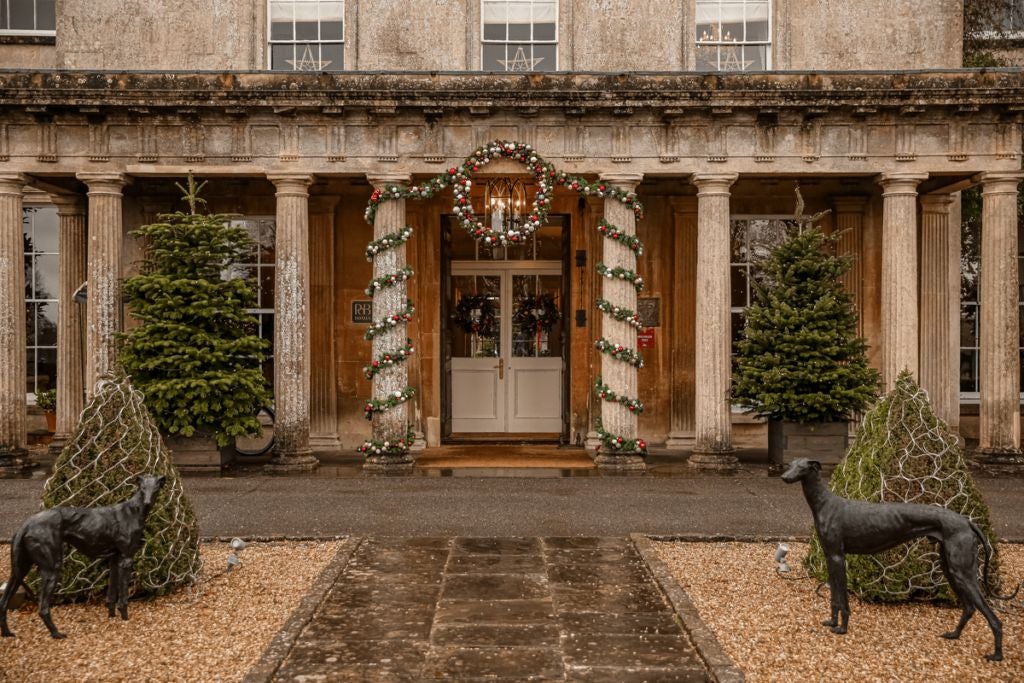 Elegant Regency-style manor nestled in lush countryside, featuring manicured gardens, stone facade, and grand architectural details of a luxurious UK country hotel spa.