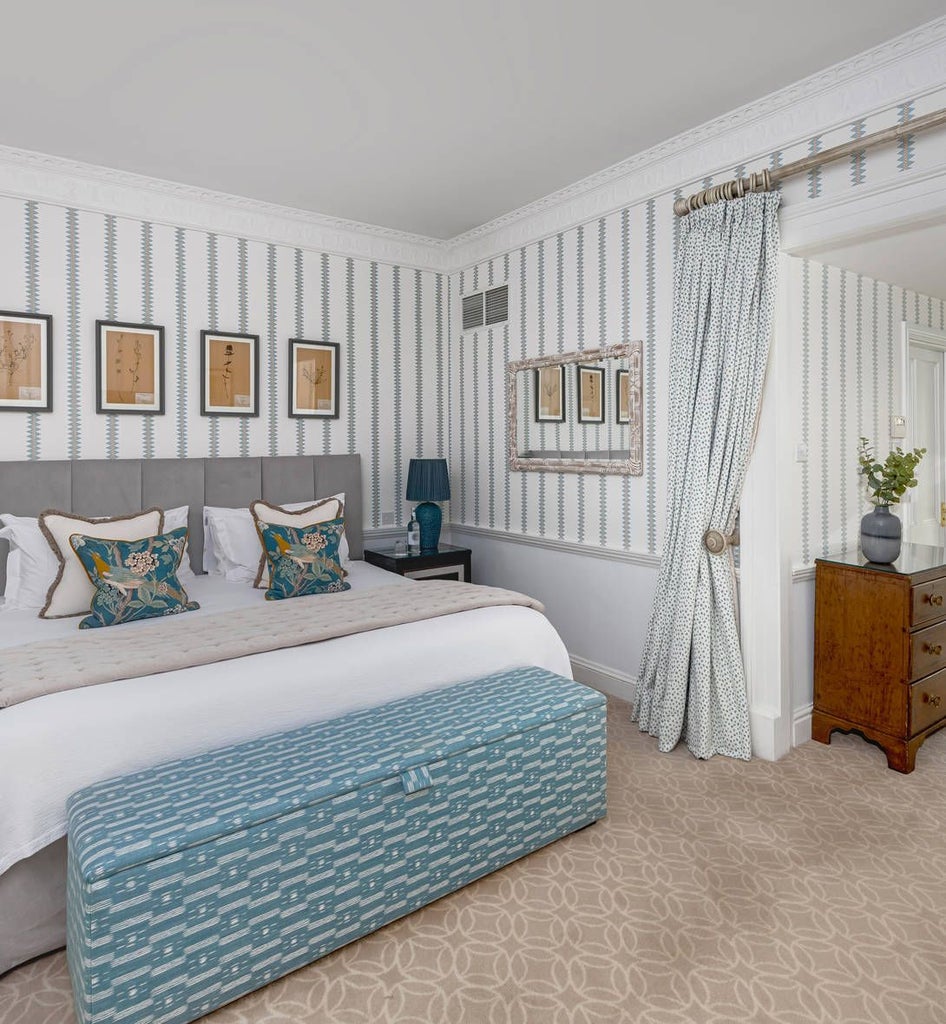 Elegant junior suite at The Royal Crescent Hotel & Spa, showcasing plush bedding, soft neutral tones, and refined architectural details in a luxurious UK setting.