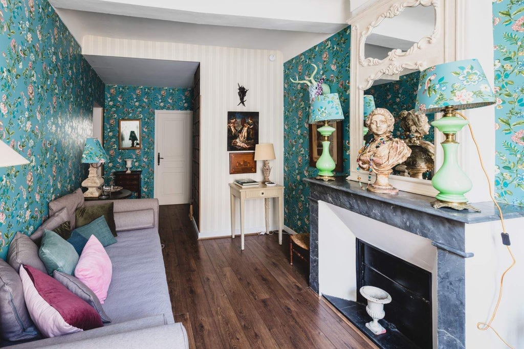 Elegant French suite with ornate four-poster bed, antique wooden furniture, and soft cream-colored walls in historic La Maison du Frêne luxury accommodation