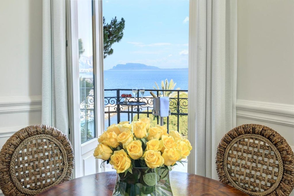 Elegant Mediterranean hotel Villa Igiea with Renaissance architecture, stone balconies, and manicured gardens overlooking Palermo's coastline