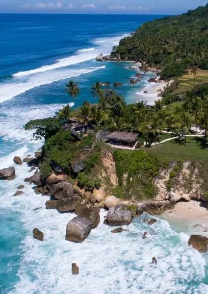 Luxurious Indonesian villa with panoramic ocean view, private infinity pool, tropical wooden deck, and lush greenery at NIHI Sumba resort