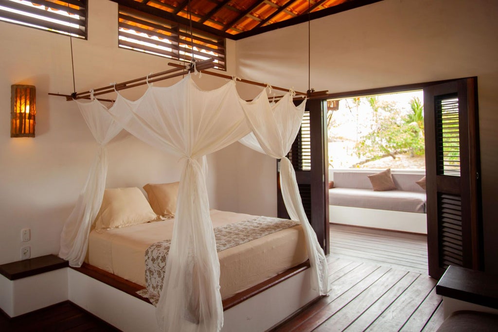 Spacious Brazilian eco-lodge bedroom with large windows overlooking lush river garden, rustic wooden furnishings, and natural light streaming across elegant interior