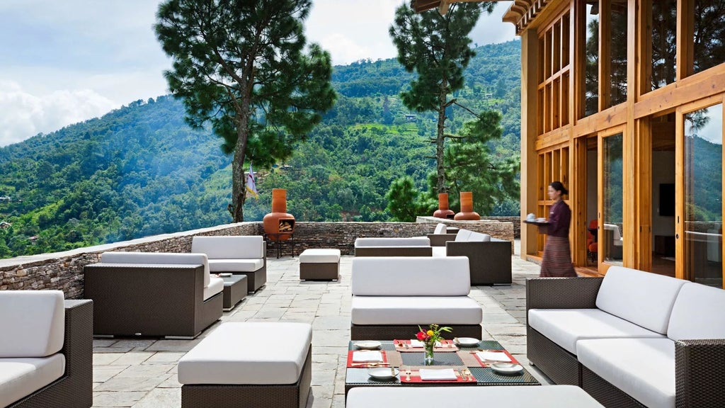 Luxurious COMO Uma Punakha hotel nestled in lush Bhutanese valley, featuring traditional architecture with sweeping mountain views and elegant design elements.