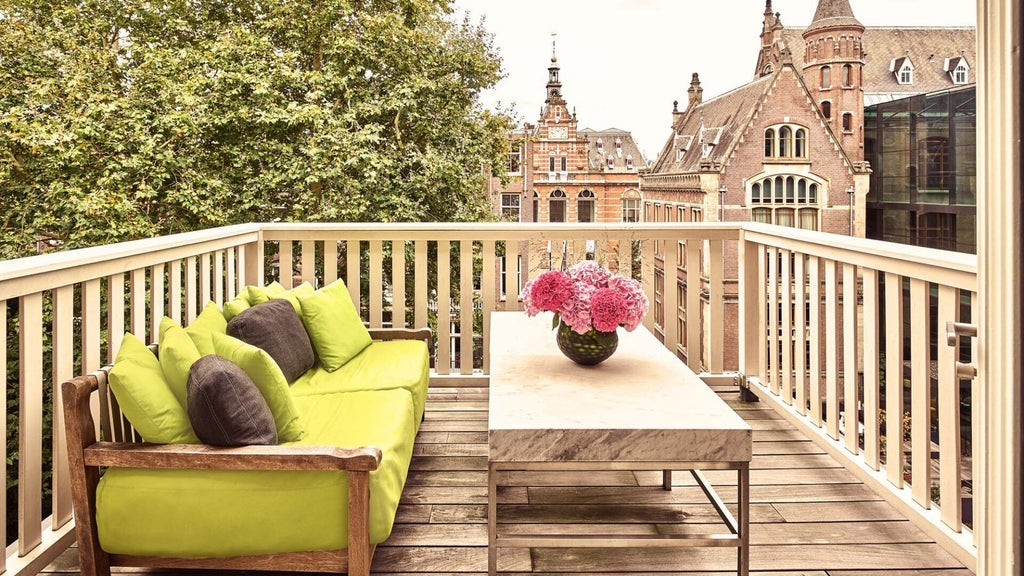 Luxurious two-bedroom hotel suite at Conservatorium, featuring elegant contemporary design, warm woods, expansive windows overlooking Amsterdam's cityscape