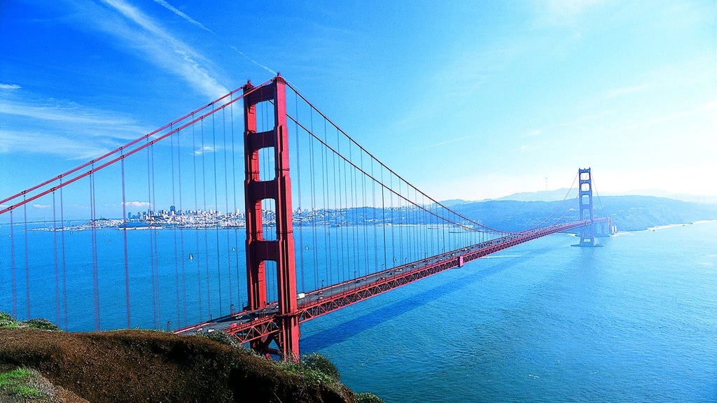 Luxurious high-rise hotel tower with sleek glass facade overlooking downtown urban landscape, elegant architectural design capturing San Francisco's modern skyline