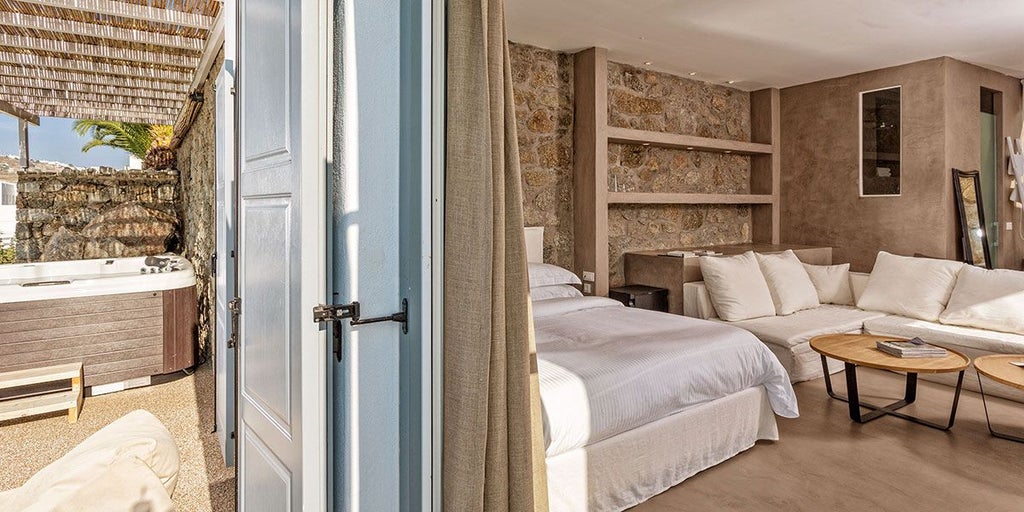 Luxurious azure-toned suite with panoramic Aegean Sea view, minimalist white decor, private balcony, and modern elegant Mediterranean design at scenset hotel