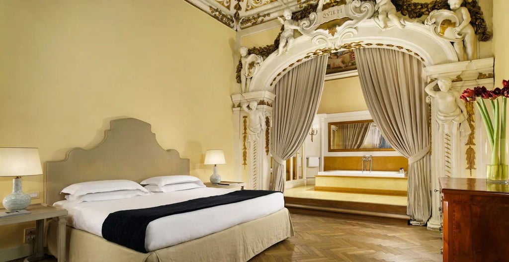 Opulent junior suite in historic Italian palazzo with ornate frescoed ceiling, antique furnishings, and plush four-poster bed overlooking elegant interior