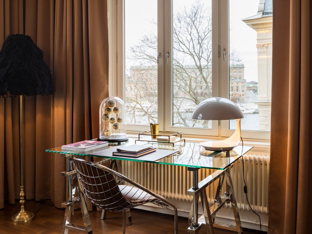 Elegant Scandinavian hotel room with expansive city views, luxurious king bed, minimalist design, warm neutral tones, and floor-to-ceiling windows