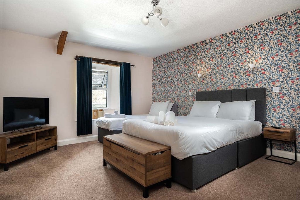 Elegant superior room at The Wheatsheaf Inn with plush bedding, soft neutral tones, classic wooden furniture, and warm ambient lighting in the UK countryside