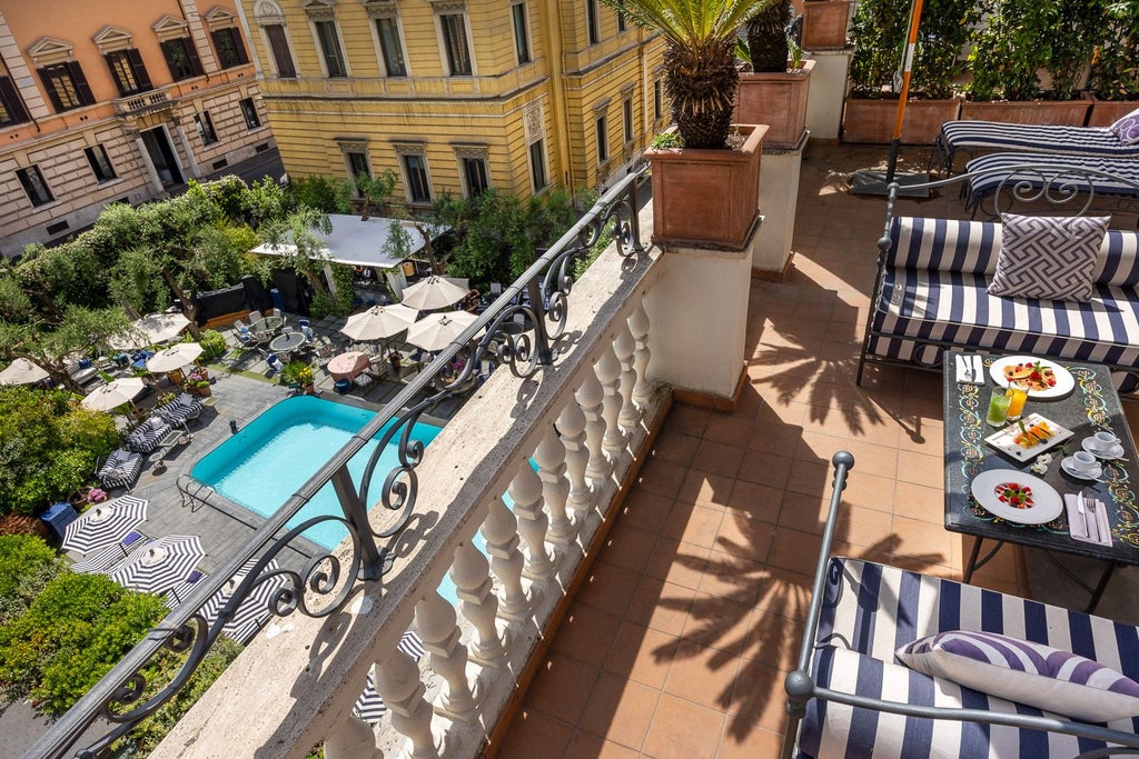 Luxurious Dama Suite at Palazzo Dama, featuring elegant white furnishings, marble accents, and panoramic windows overlooking Italian cityscape