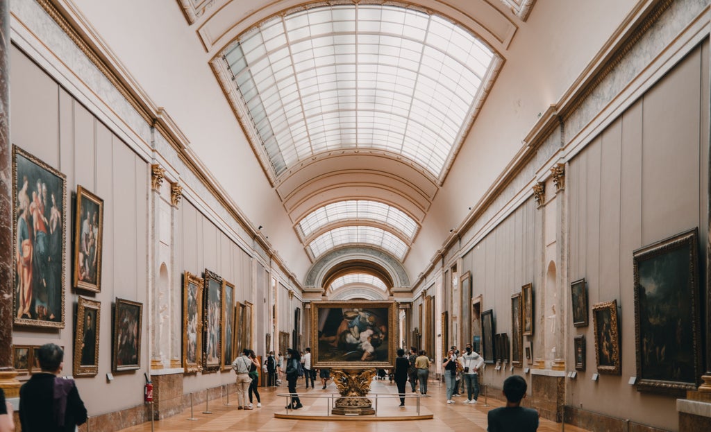 Curator guides visitors past iconic artworks in majestic halls of Louvre Museum, surrounded by ornate ceilings and marble pillars