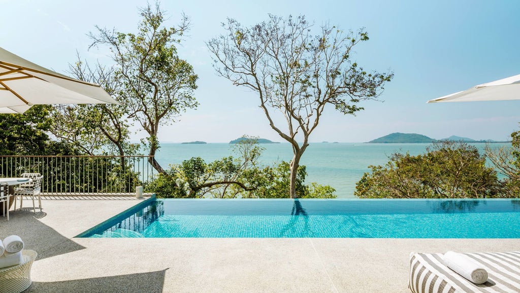 Luxurious two-bedroom villa with private pool overlooking turquoise waters, minimalist Thai design, and contemporary elegance at scenic coastal resort