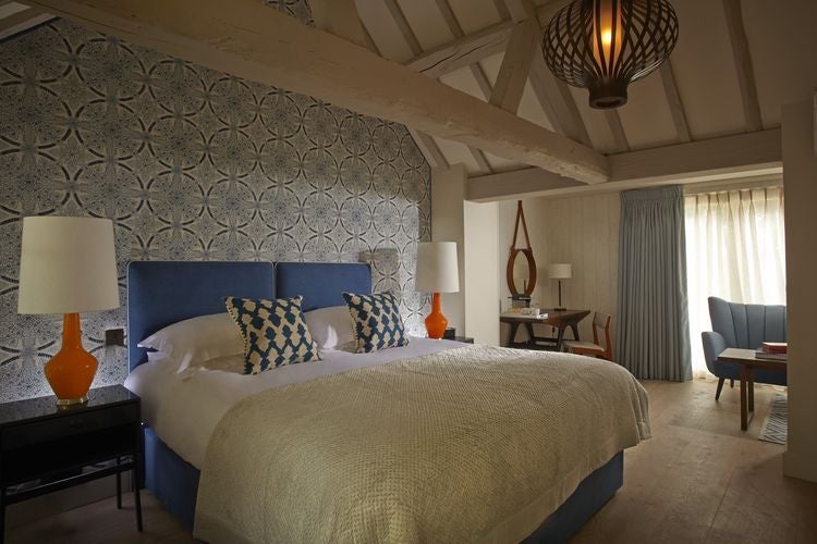 Elegant boutique hotel room with plush bedding, modern farmhouse decor, and soft neutral tones at luxury Dormy House Spa in countryside setting