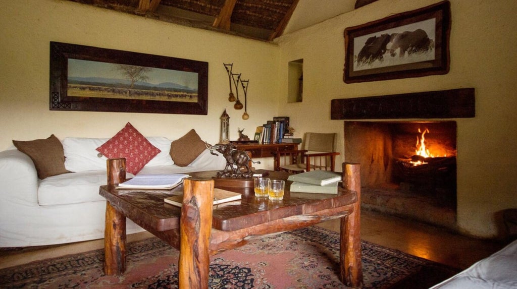 Luxurious safari tent overlooking African savanna, featuring canvas walls, private deck, and elegant outdoor furniture at sunset