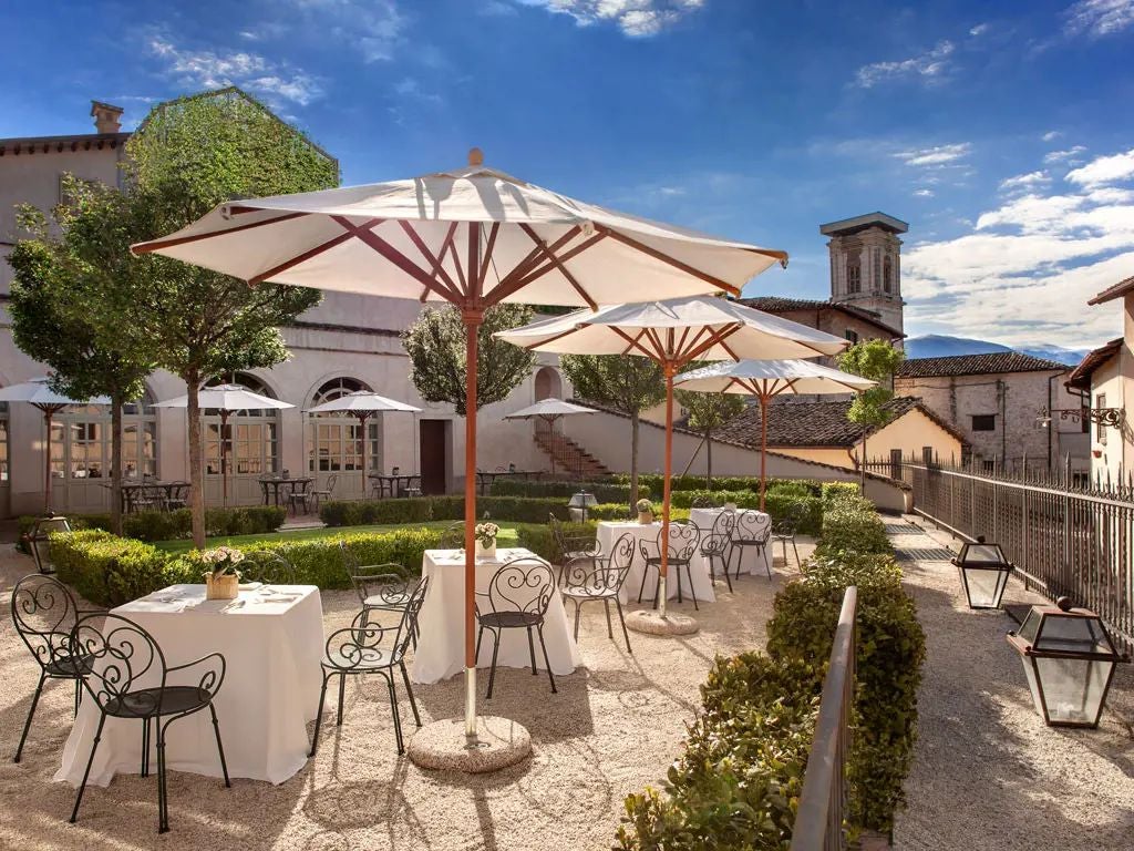 Elegant stone facade of historic Palazzo Seneca hotel in Umbria, showcasing Renaissance architecture with warm terracotta tones and traditional Italian design