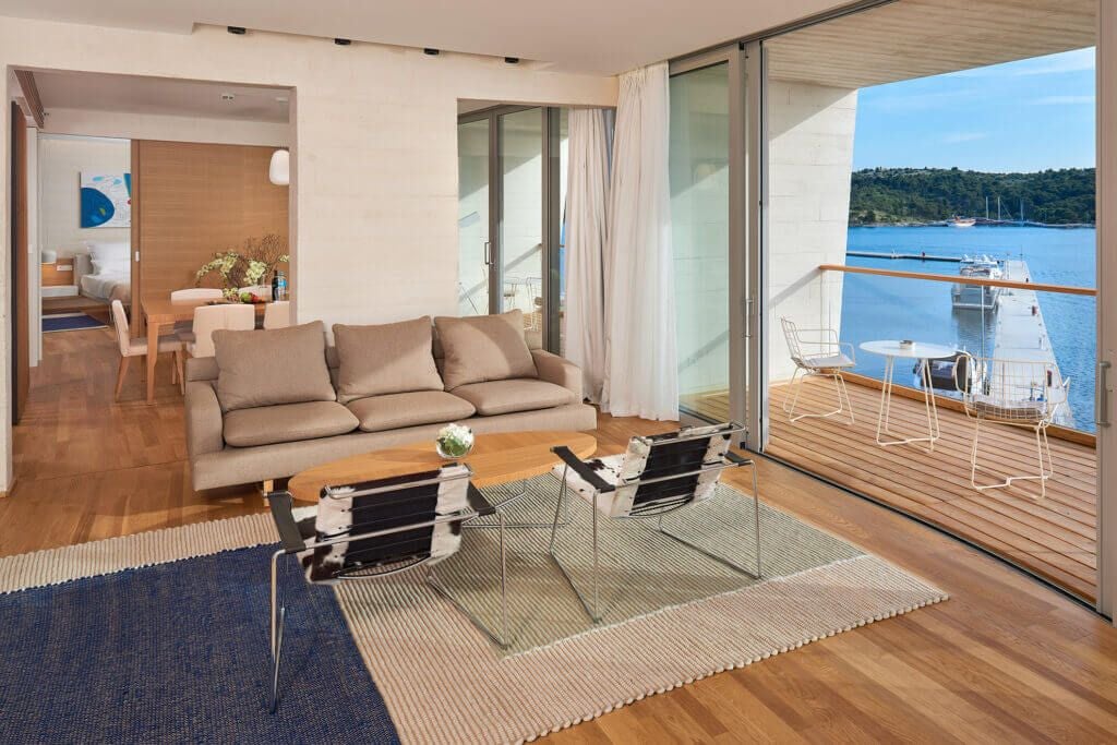 Luxurious presidential suite overlooking azure Adriatic waters, featuring modern Croatian design with elegant neutral tones and expansive floor-to-ceiling windows