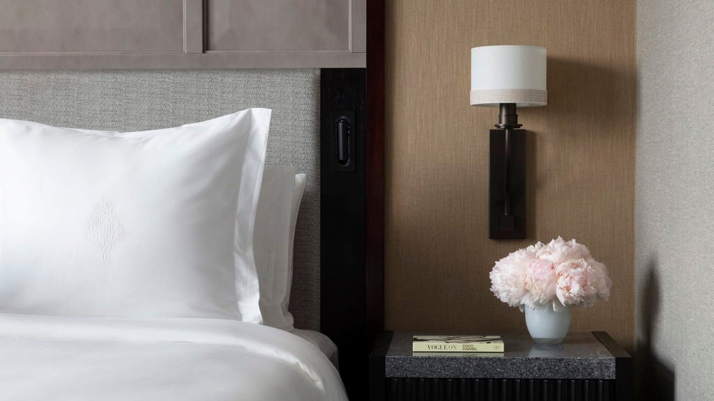 Premier hotel room with two plush queen beds, contemporary design, floor-to-ceiling windows overlooking urban scenery at scenset Hotel One Dalton Street in Boston