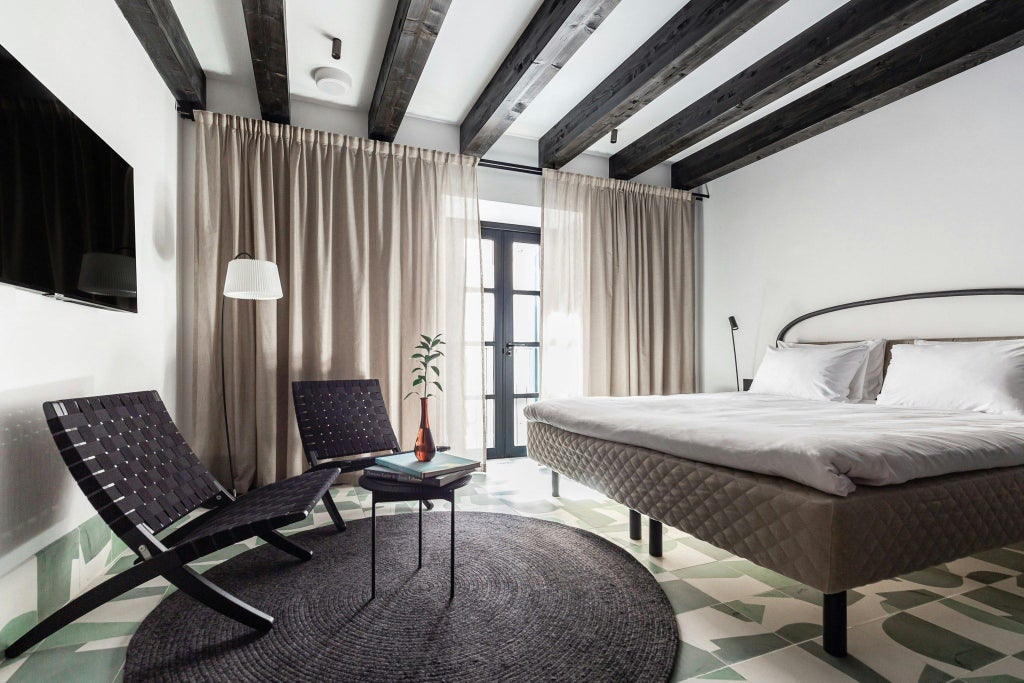 Elegant standard double room at Concepció by Nobis hotel, featuring minimalist Nordic design with warm neutral tones and sophisticated urban decor