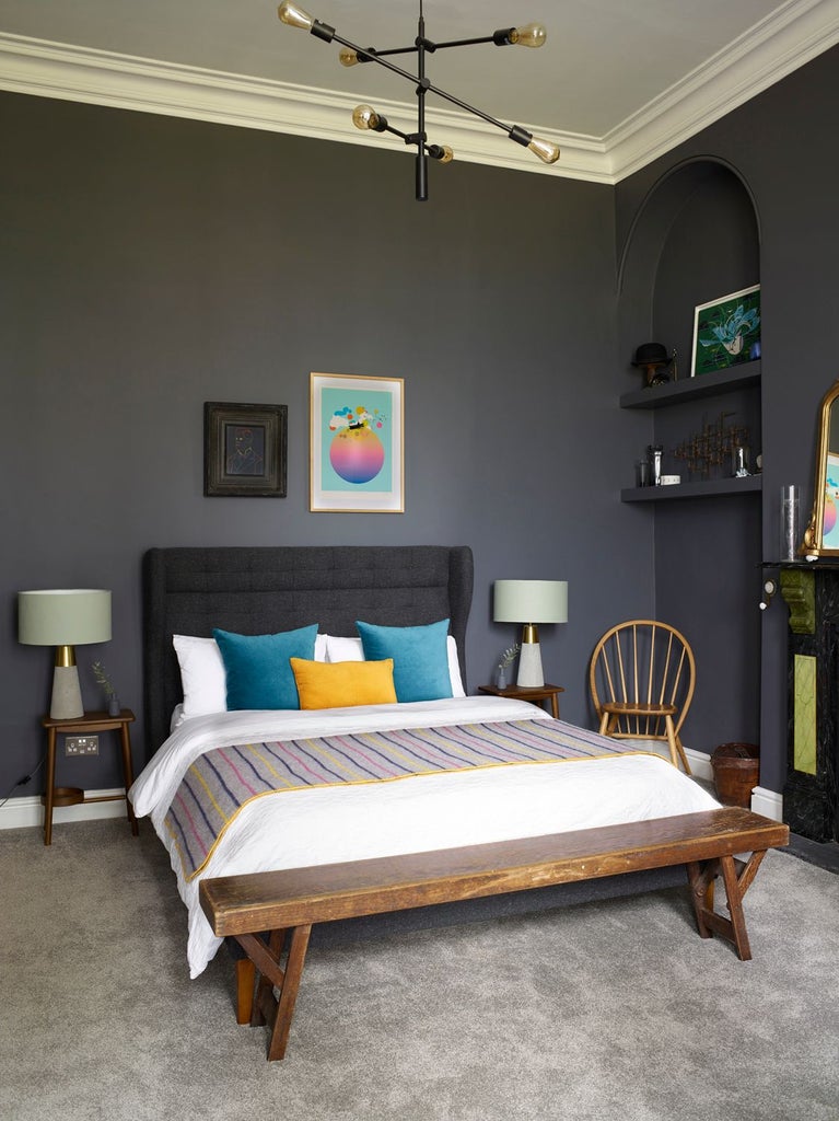 Elegant hotel bedroom with plush white bedding, soft neutral tones, modern minimalist decor, and polished hardwood floor at The Royston