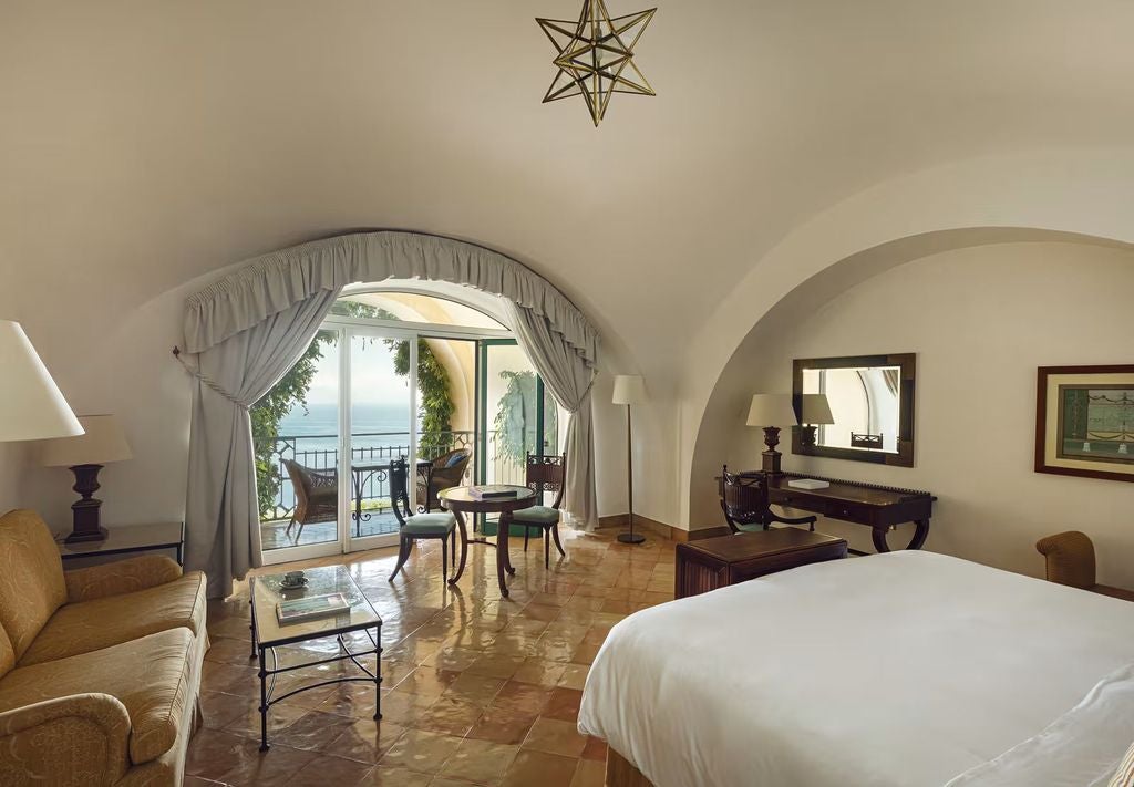 Elegant junior suite with private terrace, featuring period furnishings, marble bathroom, and panoramic views of the Amalfi Coast