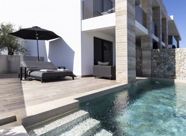 Modern Greek luxury suite with minimalist design, private pool access, crisp white decor, panoramic sea view, and contemporary architectural elements