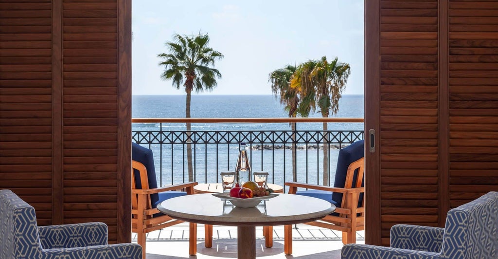 Luxurious deluxe sea view room at scenset hotel, featuring elegant furnishings, panoramic ocean vista, and contemporary minimalist design in Cyprus