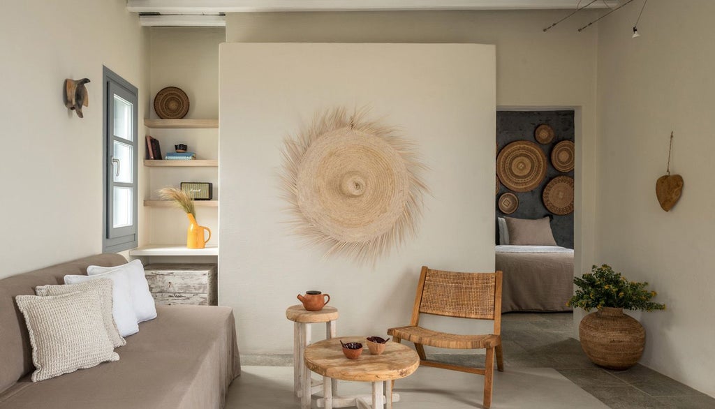 Minimalist white bedroom with blue Aegean Sea view, sleek modern furnishings, private balcony, and elegant Cycladic architectural design in Sifnos, Greece