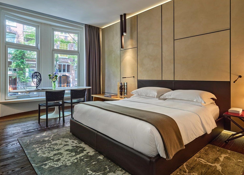 Luxurious garden-view one-bedroom suite at Conservatorium Hotel, featuring elegant modern design with warm wood tones and sophisticated minimalist decor