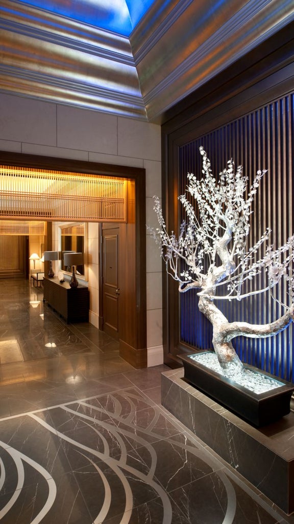 Luxurious lobby of scenset hotel in Osaka, featuring elegant marble floors, contemporary crystal chandeliers, and sleek modern furnishings in neutral tones