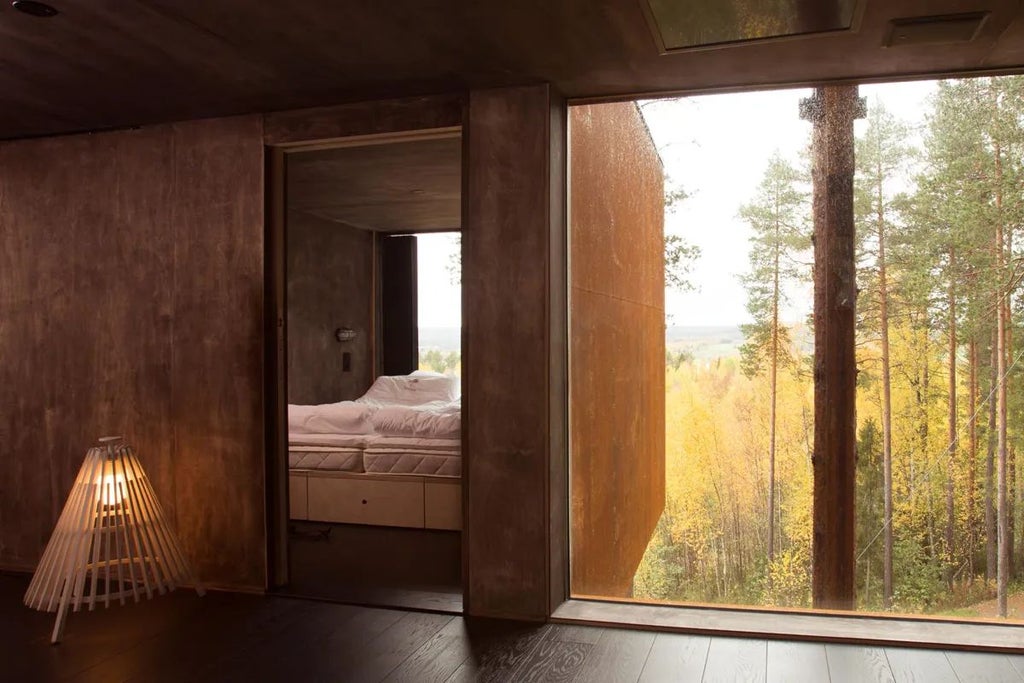 Modern architectural room suspended among trees in Swedish forest, metallic dragonfly-inspired exterior with reflective mirrored glass walls blending with surrounding pine landscape