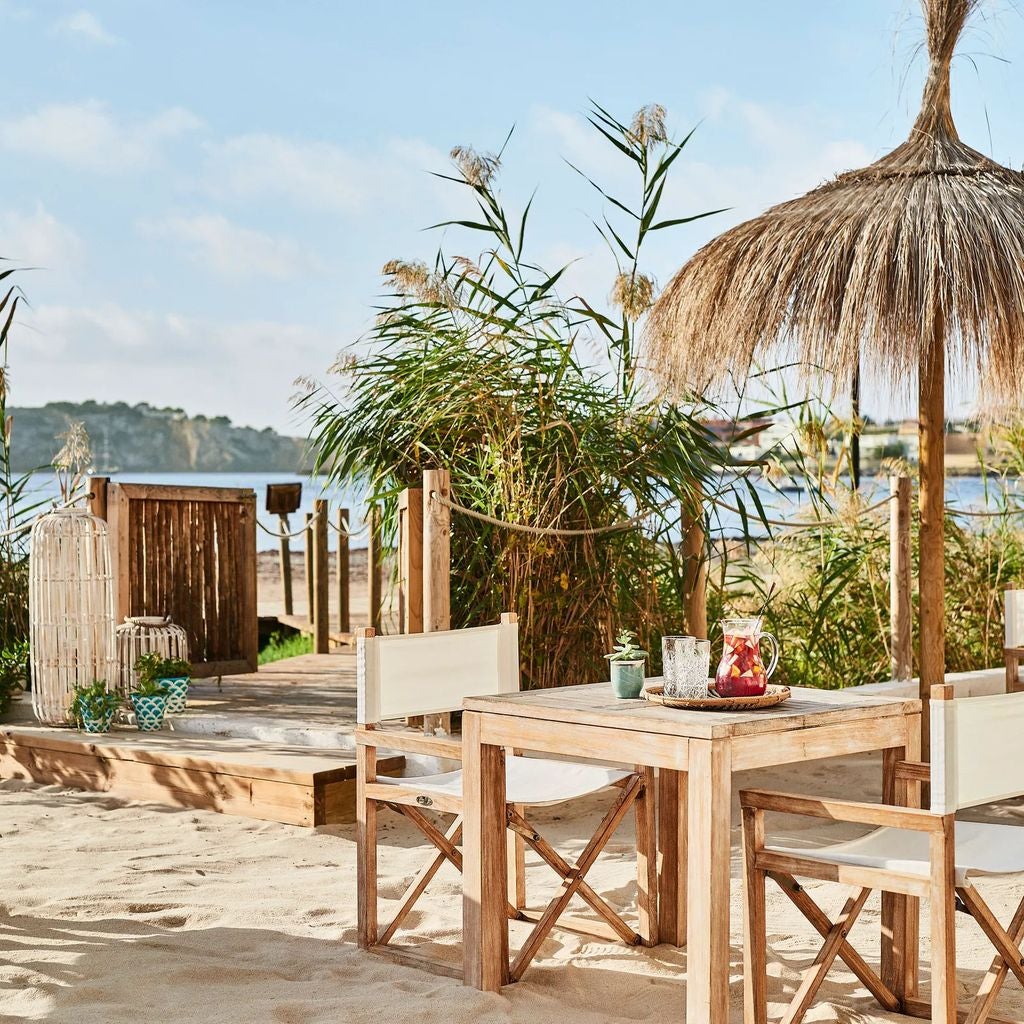 Luxurious Nobu Hotel Ibiza Bay features sleek white architecture and beachfront terraces overlooking crystal-clear Mediterranean waters