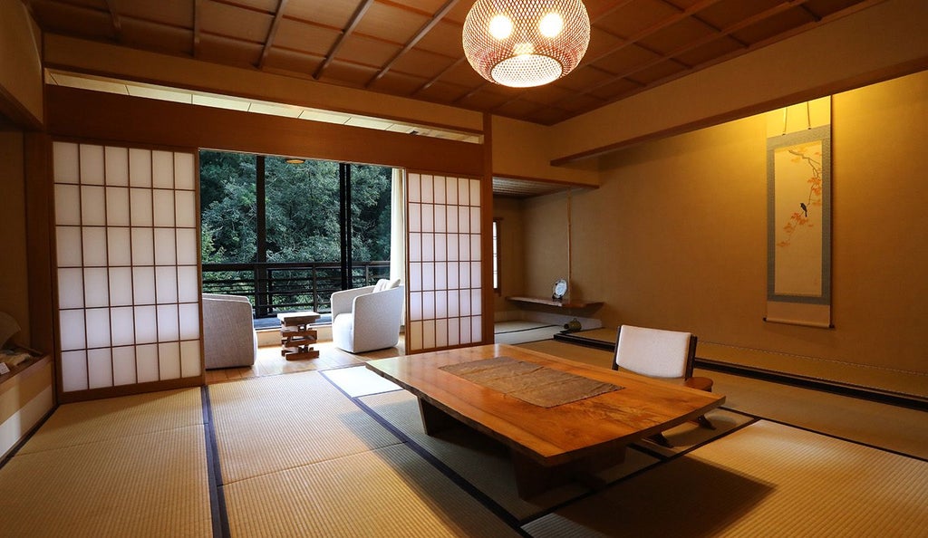 Minimalist Japanese ryokan nestled in lush forest, traditional wooden architecture with elegant tatami rooms and serene onsen view, soft natural lighting