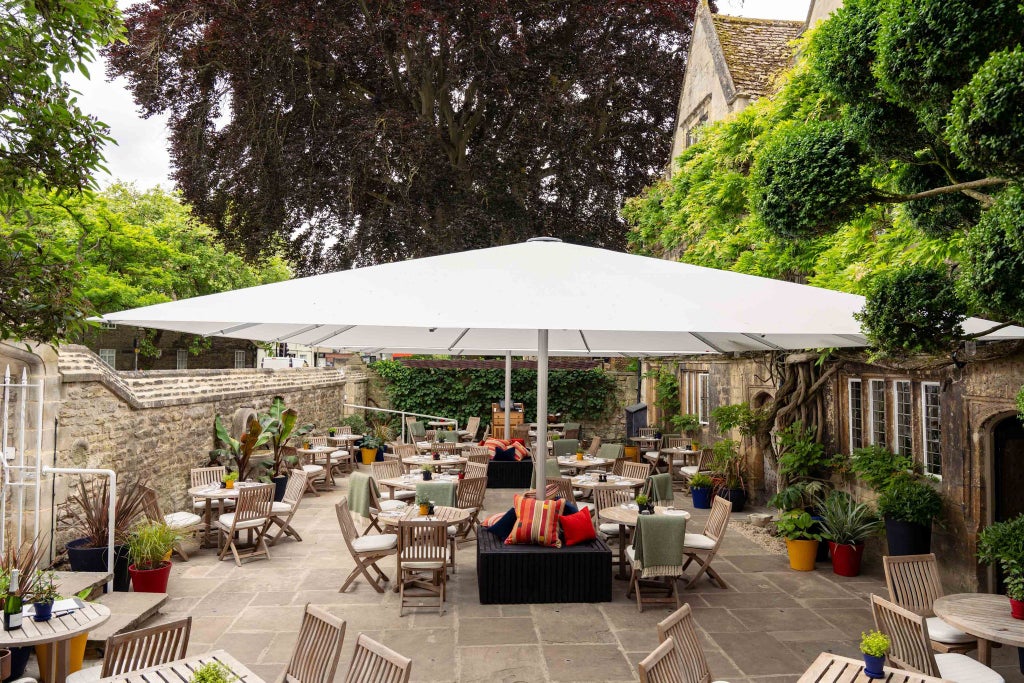 Elegant classic room at Old Parsonage Hotel, featuring crisp white linens, traditional wooden furnishings, and soft neutral color palette in a charming UK setting.