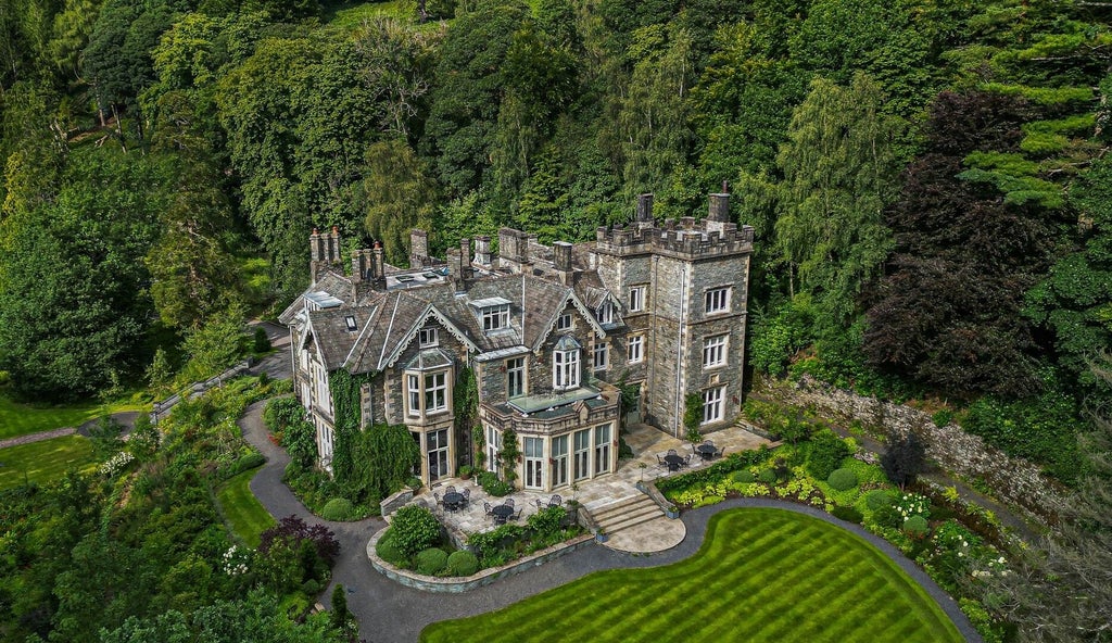 Luxurious woodland hotel exterior with rustic stone facade, surrounded by lush green forest in scenic UK countryside at dusk