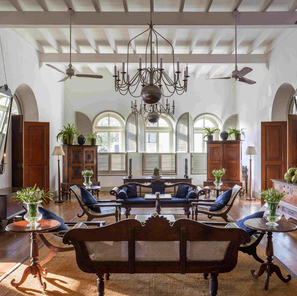 Historic colonial-style luxury hotel in Galle, Sri Lanka, with whitewashed walls, terracotta roof tiles and lush tropical gardens surrounding