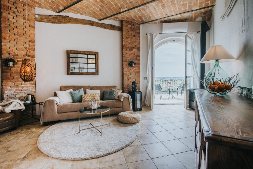 Elegant junior suite with panoramic windows, plush white bedding, modern Italian design, and soft neutral tones overlooking scenic Mediterranean landscape