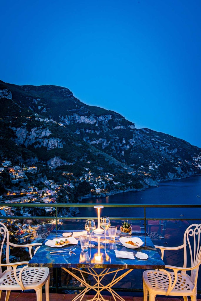 Luxury cliffside hotel in Positano with multi-level terraces, infinity pools, and panoramic views of the Mediterranean coastline