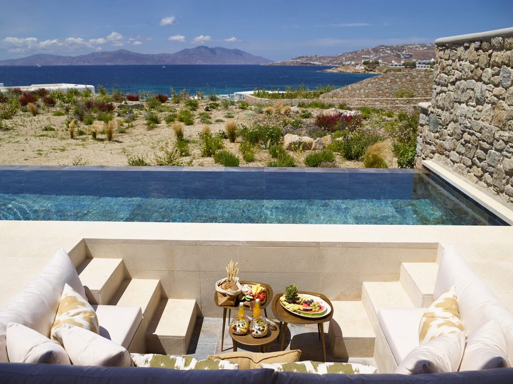 Luxurious two-bedroom villa in Mykonos with private heated pools, stunning sea views, and contemporary Greek island architecture and design