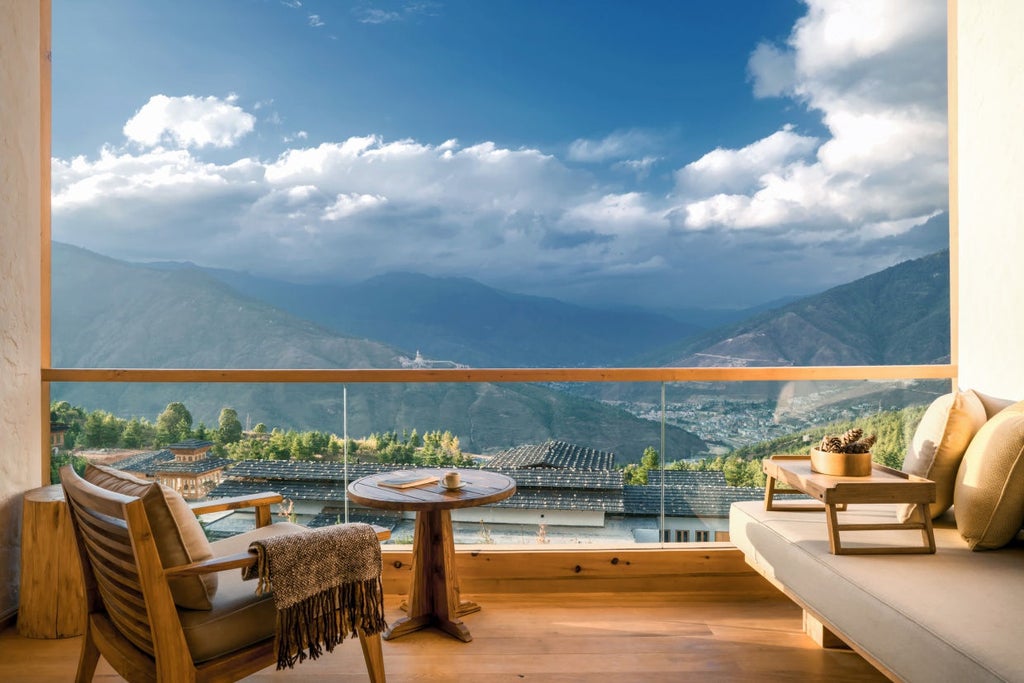 Luxurious mountain lodge with traditional Bhutanese architecture featuring wooden beams, white walls and panoramic Himalayan views