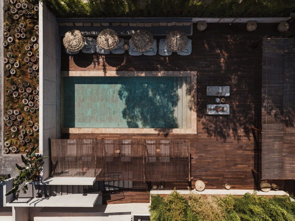 Luxurious white-washed beachfront hotel with minimalist design, infinity pool overlooking turquoise Mediterranean waters, golden sunlight on sleek architectural surfaces