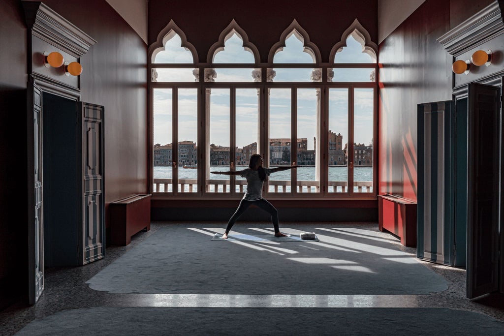 Luxurious Italian palazzo hotel with ornate stone facade, elegant balconies, and warm Mediterranean lighting against historic Venetian architectural backdrop