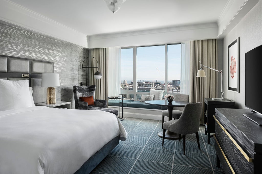 Modern luxury high-rise hotel in San Francisco's financial district, featuring glass exterior and panoramic views of the Bay Bridge