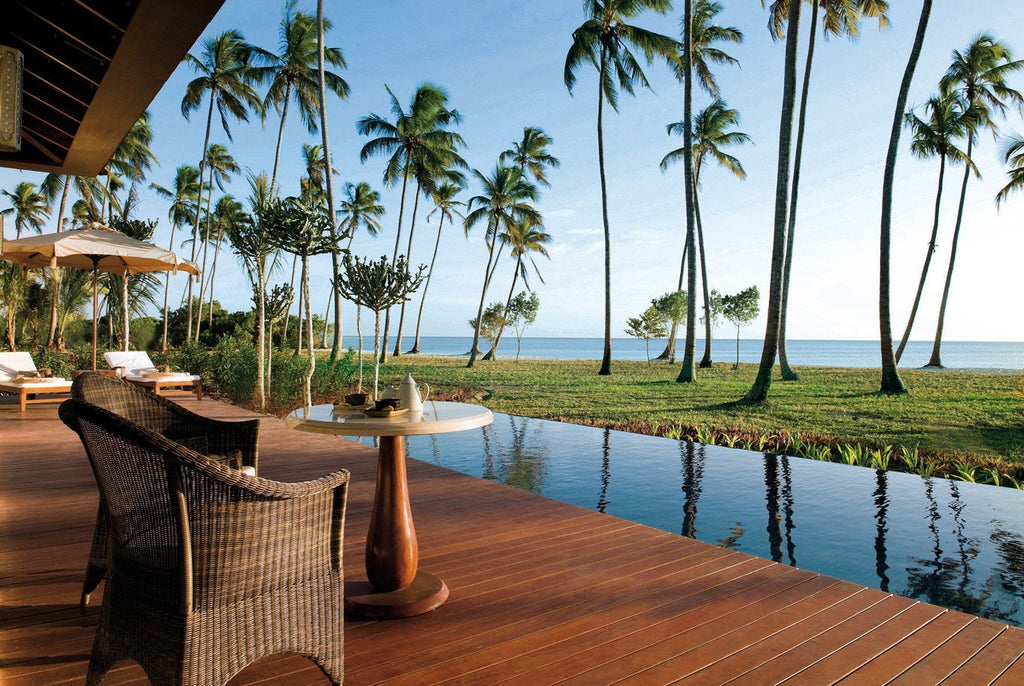 Luxurious beachfront villa with private infinity pool overlooking turquoise Indian Ocean waters at The Residence Zanzibar resort