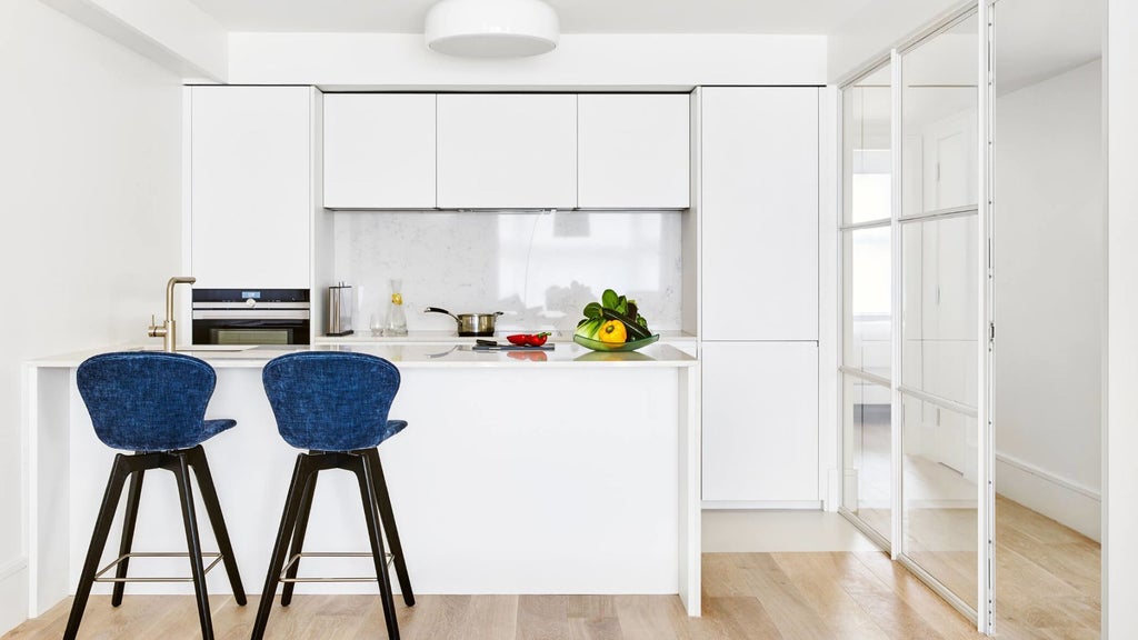 Luxurious contemporary hotel room at COMO Metropolitan London with minimalist design, plush white bedding, and elegant cityscape view from Brick Street Residences