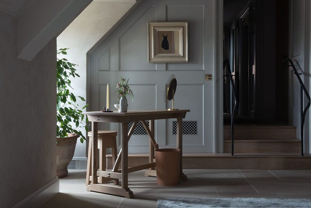 Elegant long room at Heckfield Place, featuring soft neutral tones, plush seating, expansive windows, and refined English countryside aesthetic