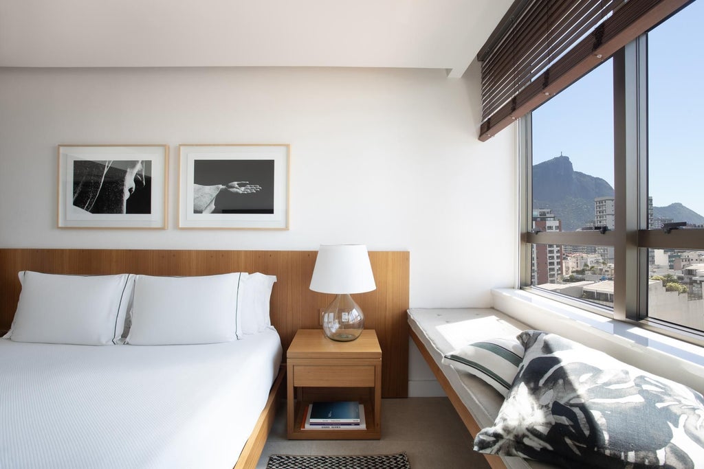 Luxurious deluxe hotel room at Janeiro Hotel with sleek modern design, panoramic ocean view, minimalist furniture, and warm Brazilian aesthetic