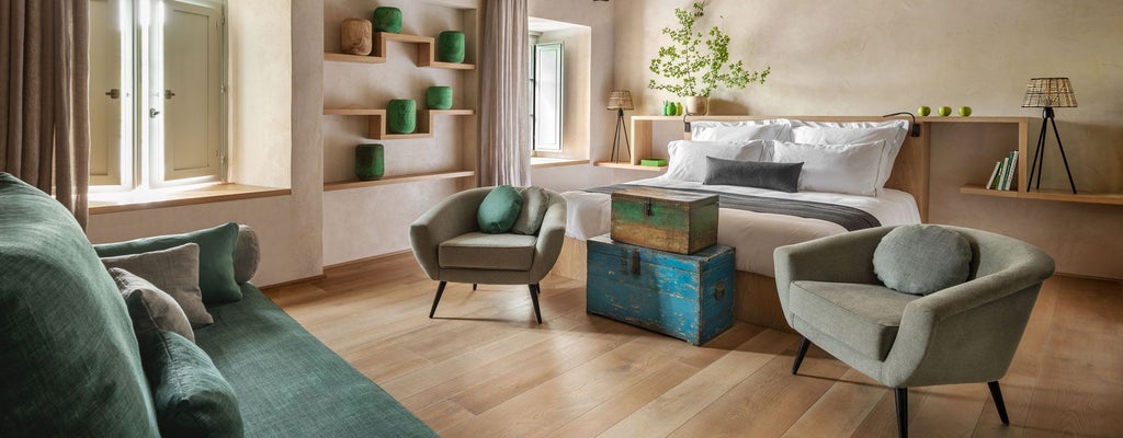 Elegant Italian junior suite with rustic wooden furniture, soft natural lighting, and luxurious bed overlooking scenic Tuscan countryside landscape