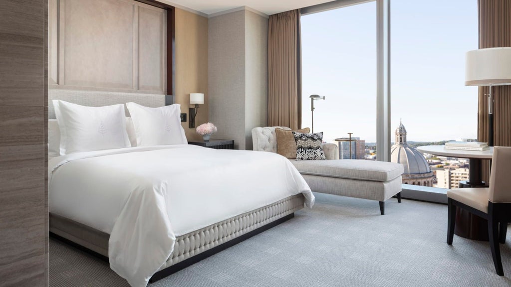 Luxurious deluxe hotel room with panoramic city views, modern elegant furnishings, and floor-to-ceiling windows at Four Seasons Hotel in downtown scenset